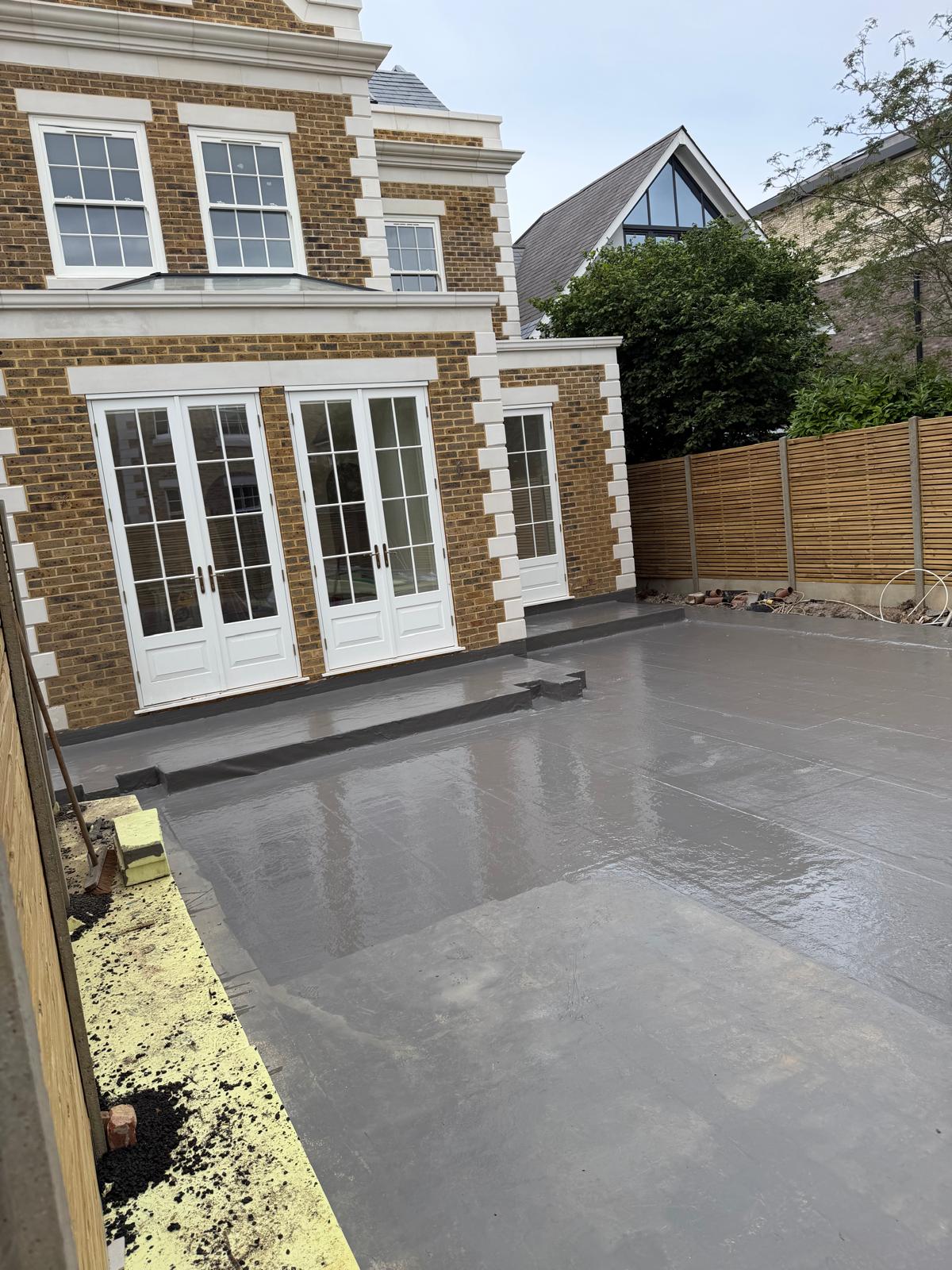 Waterproofed residential deck viewed towards the house