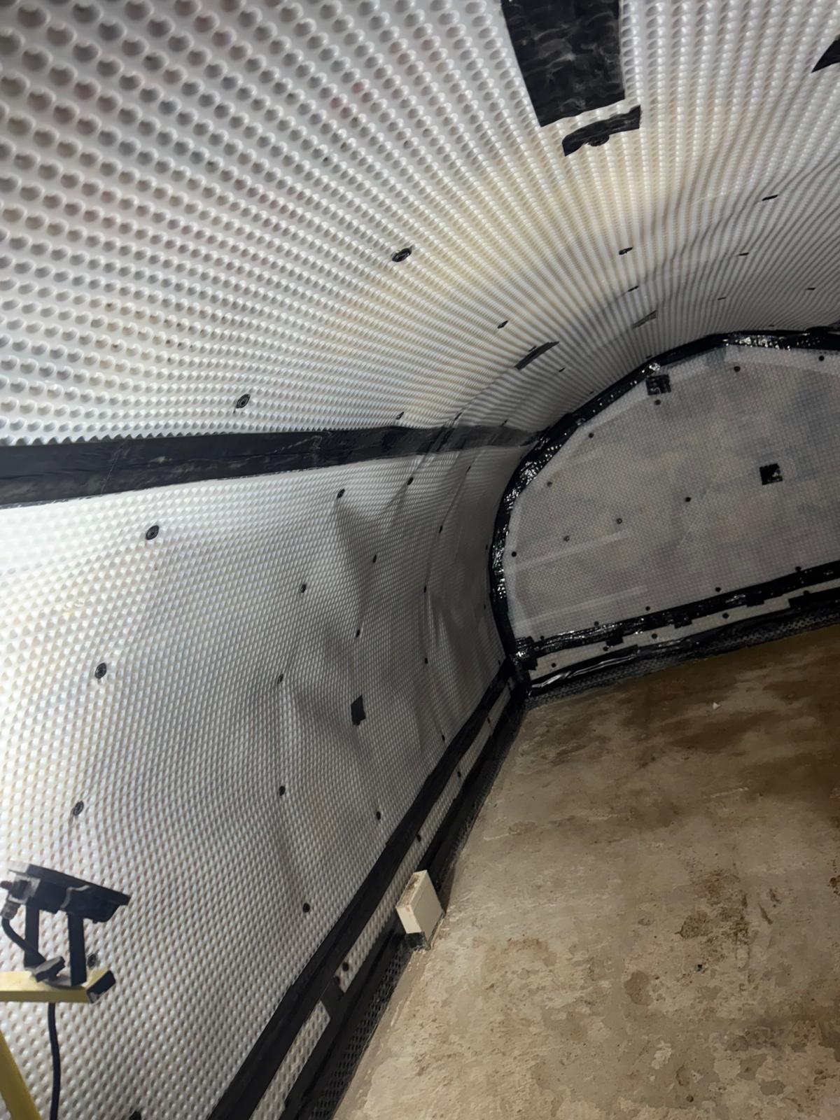 Membrane installed across a vaulted cellar ceiling and walls